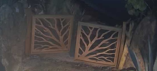 Ajar beach gate at night, spotlight on, visible parting between frames.